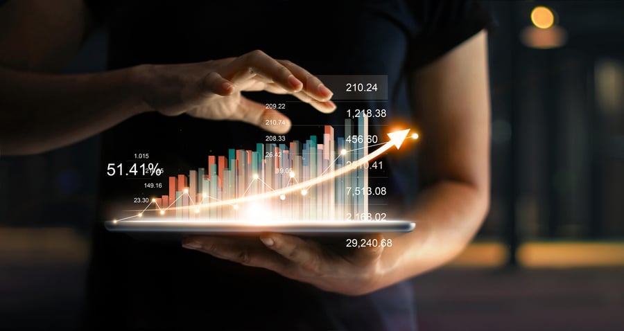 Hand carrying a tablet projecting 3d sales revenue in an increasing output